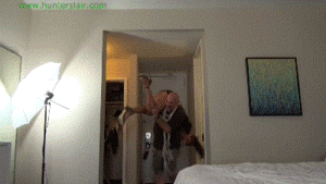 www.jimhunterslair.com - Tossed on her bed and wrestled into a cruel crotch roped hogtie thumbnail