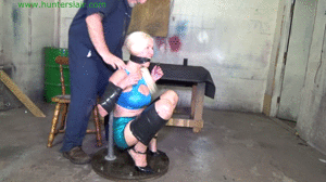www.jimhunterslair.com - Busty blond MILF taped up tight on the girlie-go-round thumbnail